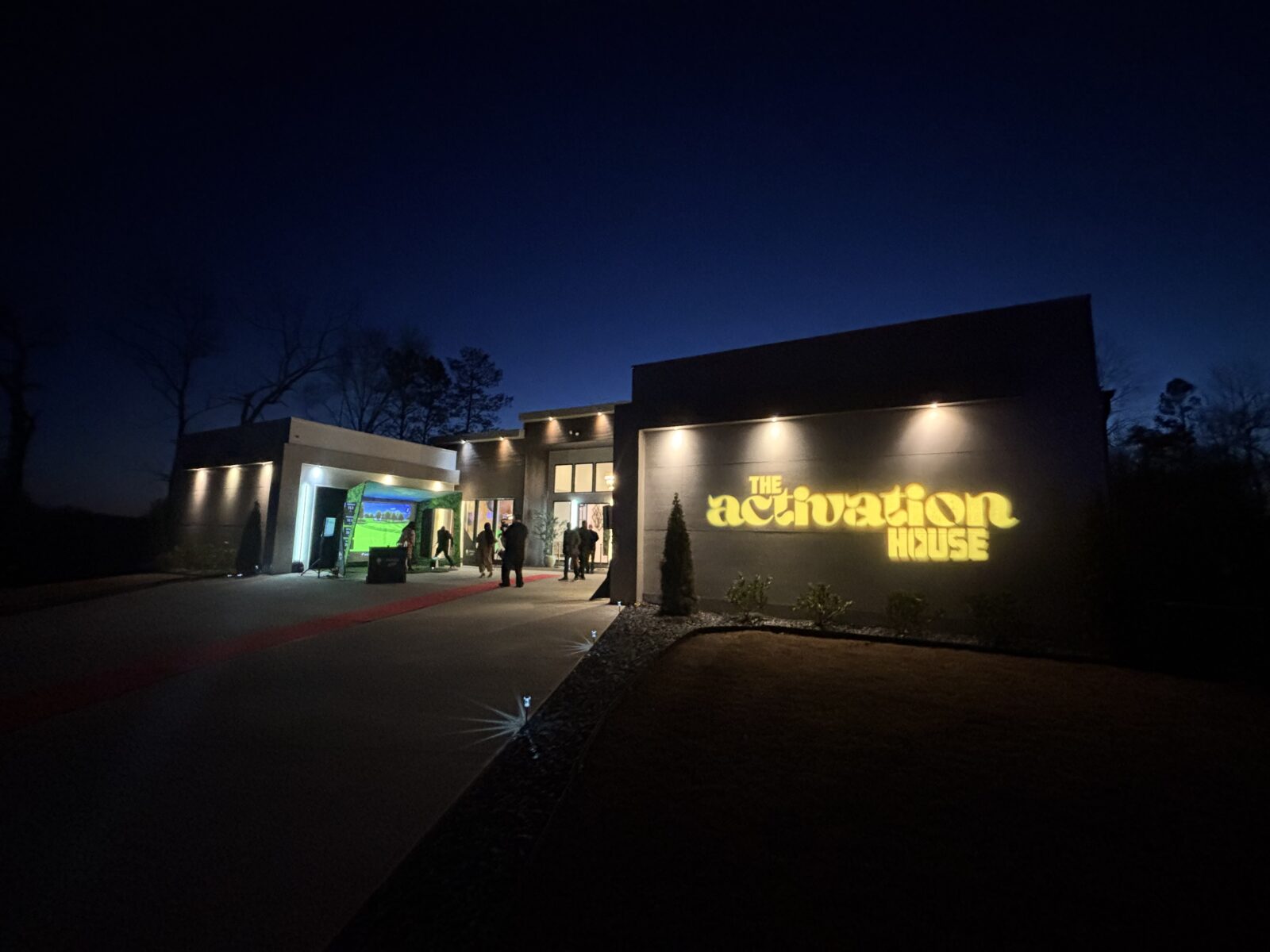 The Activation House in Atlanta illuminated with architectural lighting and red carpet entrance during a private corporate brand activation supported by Innovent Technologies.