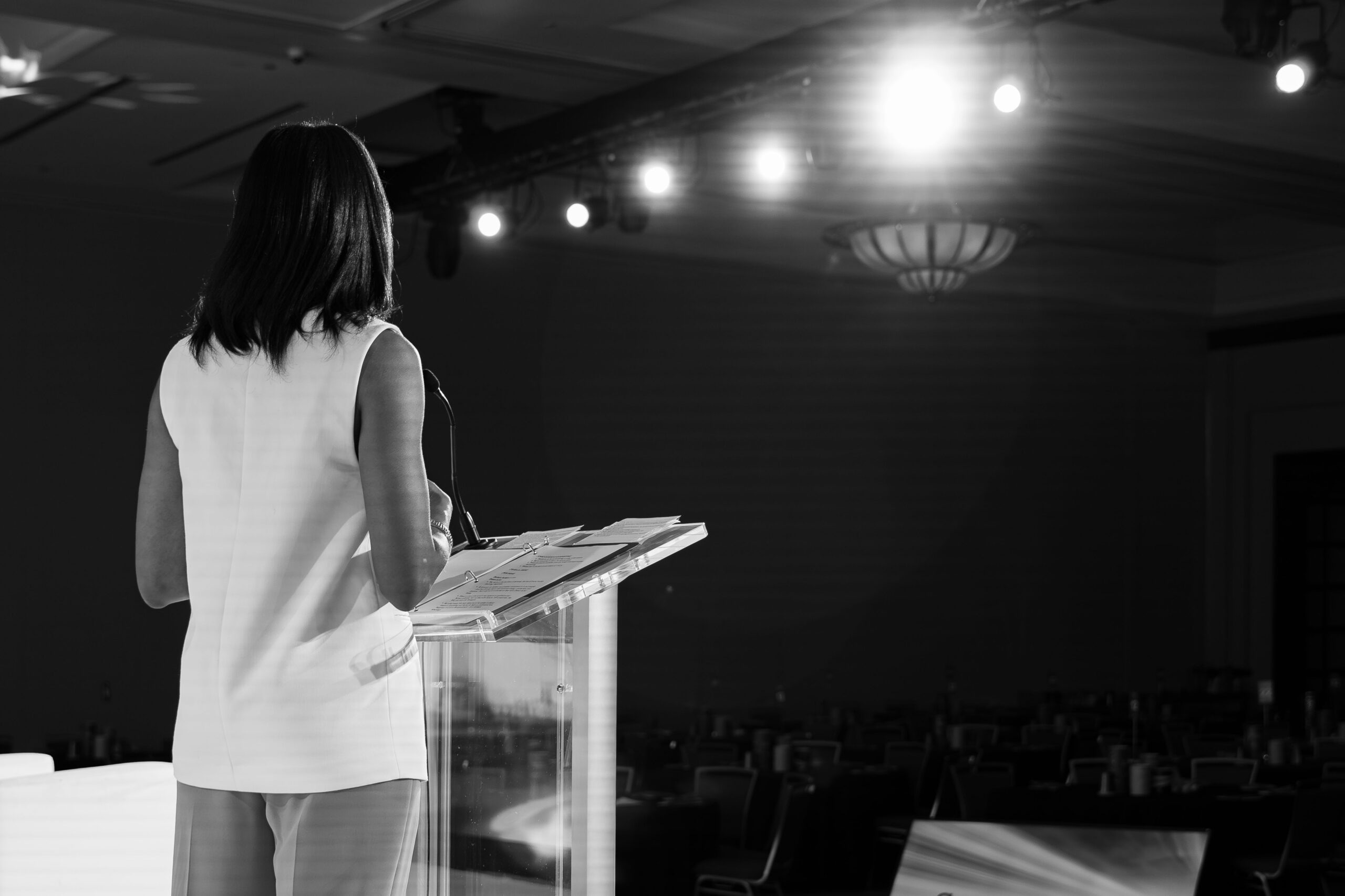 atlanta corporate event speaker stage lighting production.jpg Corporate speaker presenting on stage with professional lighting and audio production at an Atlanta conference