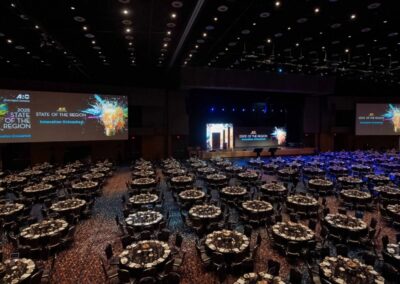 Large ballroom general session setup with LED stage, projection screens, and full AV production by Innovent Technologies in Atlanta