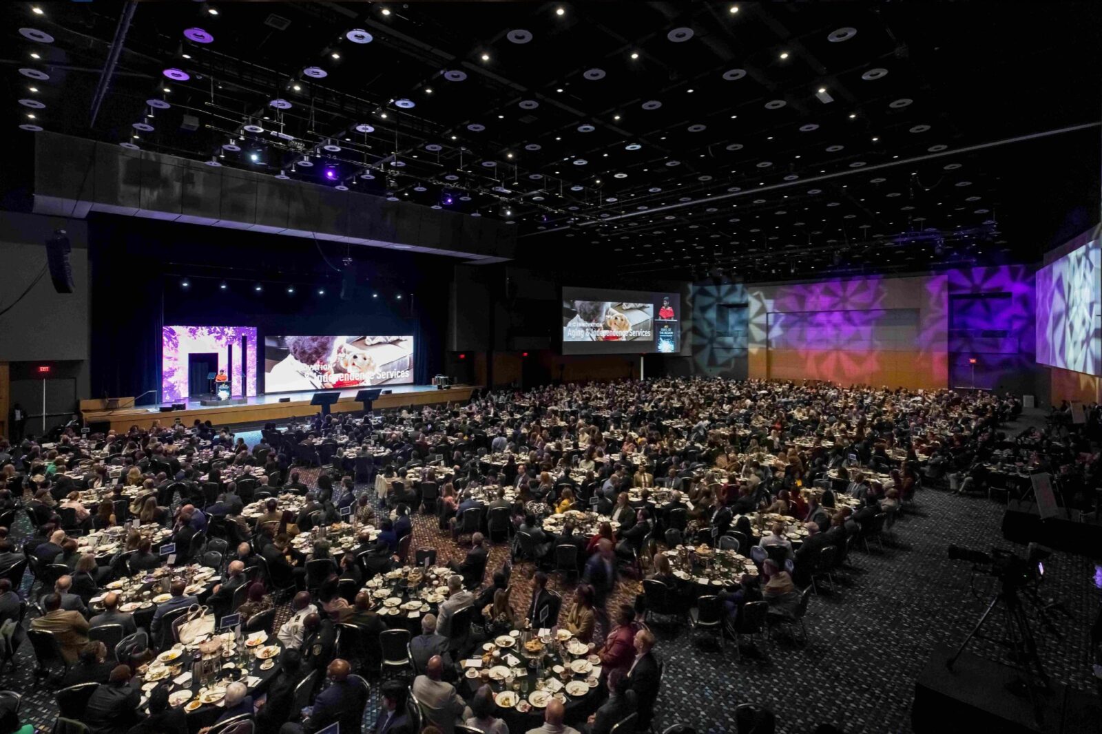 Large-scale ballroom general session for the Atlanta Regional Commission State of the Region with LED stage design, projection screens, and full audience seating