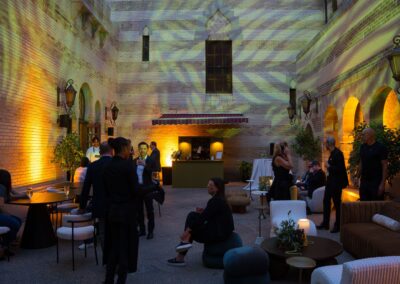 Corporate networking lounge with projection mapping, ambient lighting, and scenic event design