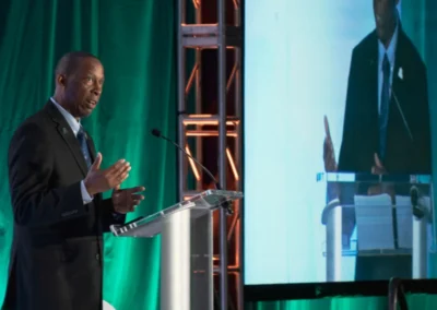Keynote speaker presenting on stage with IMAG live video display and professional event production by Innovent Technologies