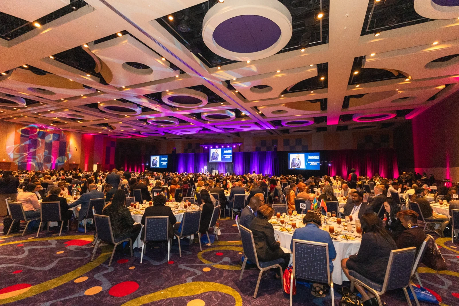 Large-Scale Gala and Conference Production | Innovent Technologies Large-scale gala event with stage lighting, IMAG screens, and audience seating for corporate conference production by Innovent Technologies