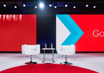 Corporate general session stage for Synovus featuring large LED video walls, modern seating setup, and clean event staging design in Atlanta