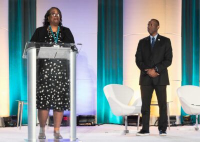 Executive keynote presentation with lectern and stage lighting at NCSEA Leadership Symposium