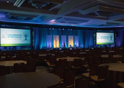 NCSEA Leadership Symposium general session stage with dual projection screens and scenic lighting