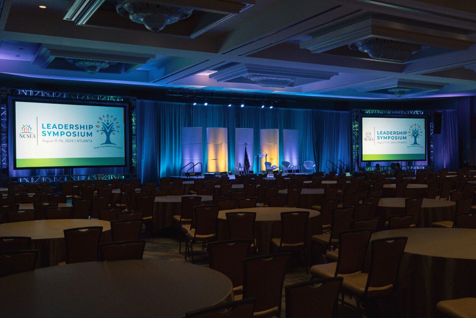 NCSEA Leadership Symposium general session stage with dual projection screens and scenic lighting