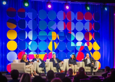 Corporate panel discussion on stage with custom LED backdrop and event lighting design in Atlanta by Innovent Technologies