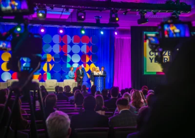 Corporate event stage with LED backdrop, lighting design, and live camera recording setup in Atlanta by Innovent Technologies