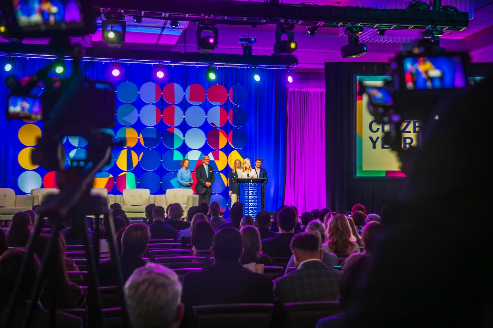 Corporate event stage with LED backdrop, lighting design, and live camera recording setup in Atlanta by Innovent Technologies