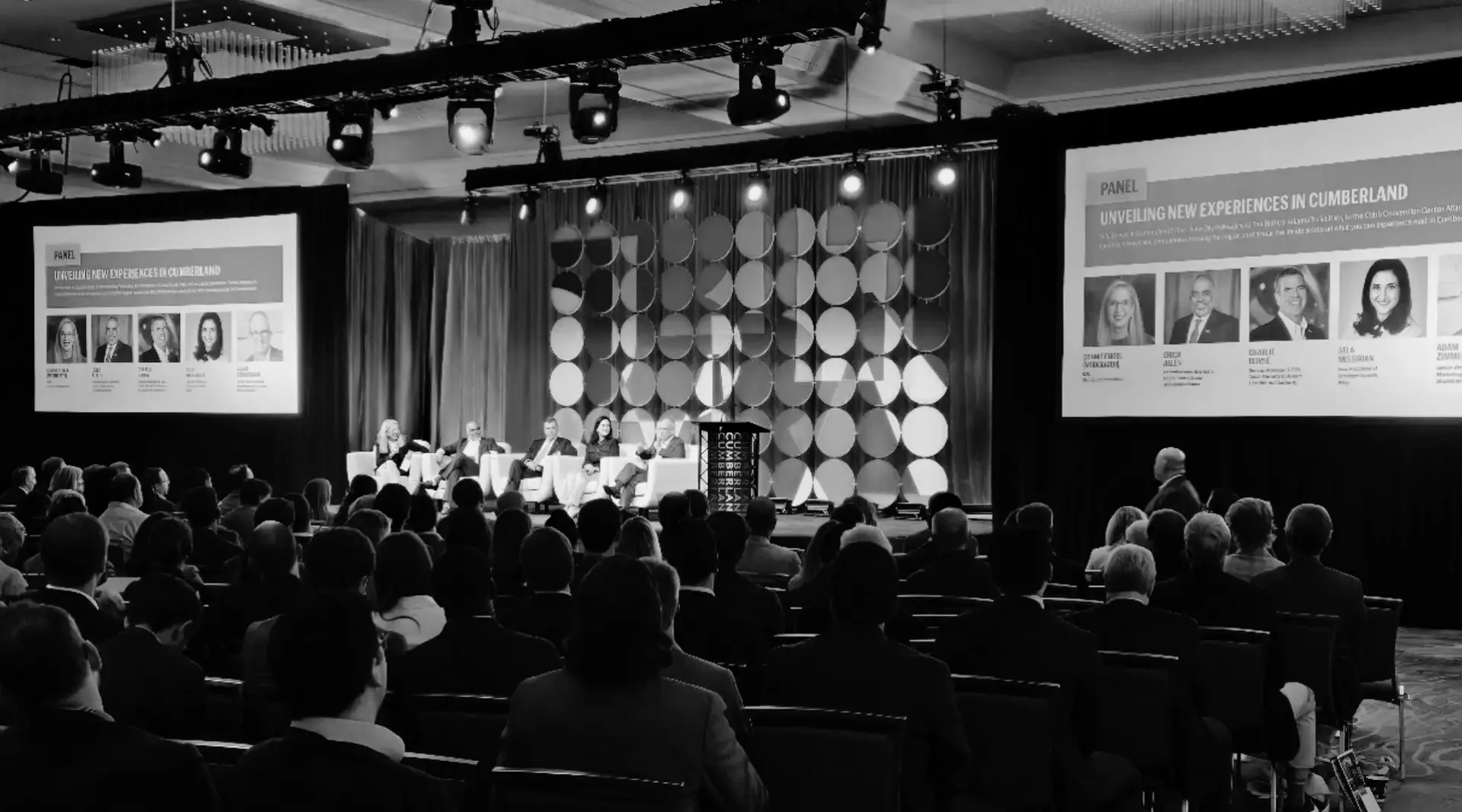 Stage production for the Cumberland CID Annual Community Meeting at Cobb Galleria Centre in Atlanta with projection screens, lighting truss, and circular scenic backdrop