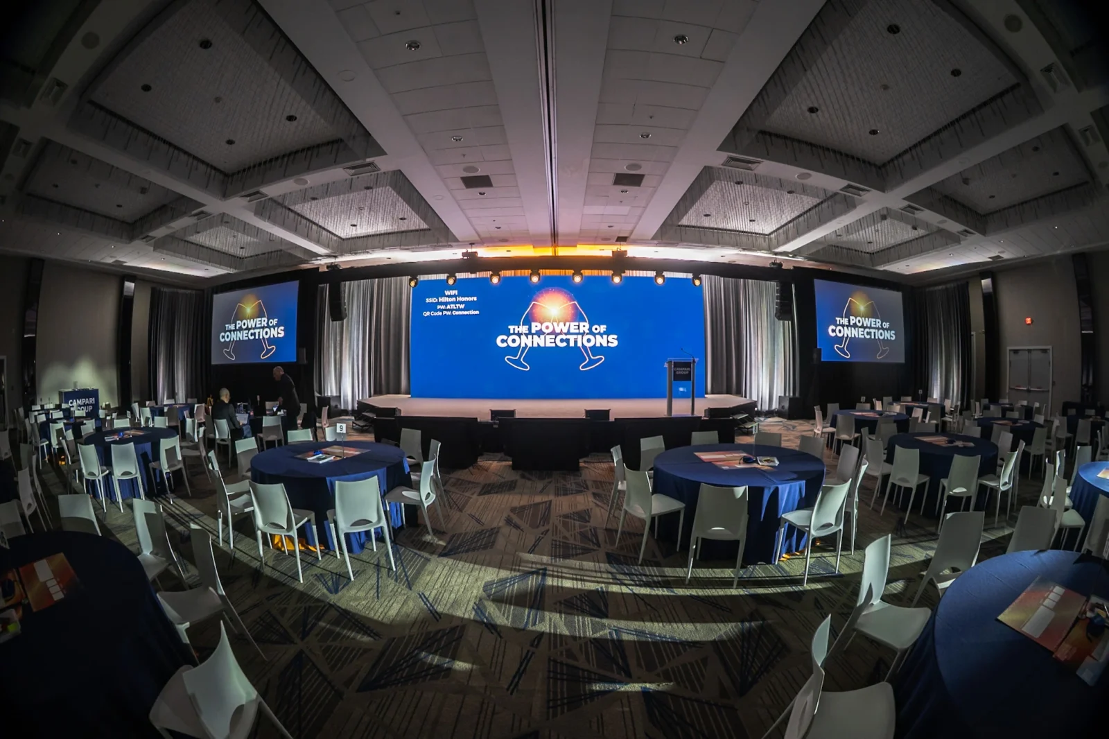 Conference stage design featuring LED video wall and projection screens Corporate conference general session stage with large LED video wall and dual projection screens in ballroom