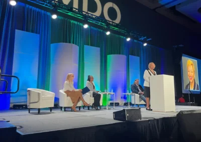 SMDO 2026 keynote speaker at podium with panel seating and stage lighting design by Innovent Technologies
