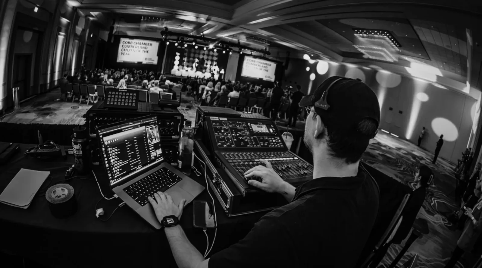 AV technician managing show control during a corporate conference event production
