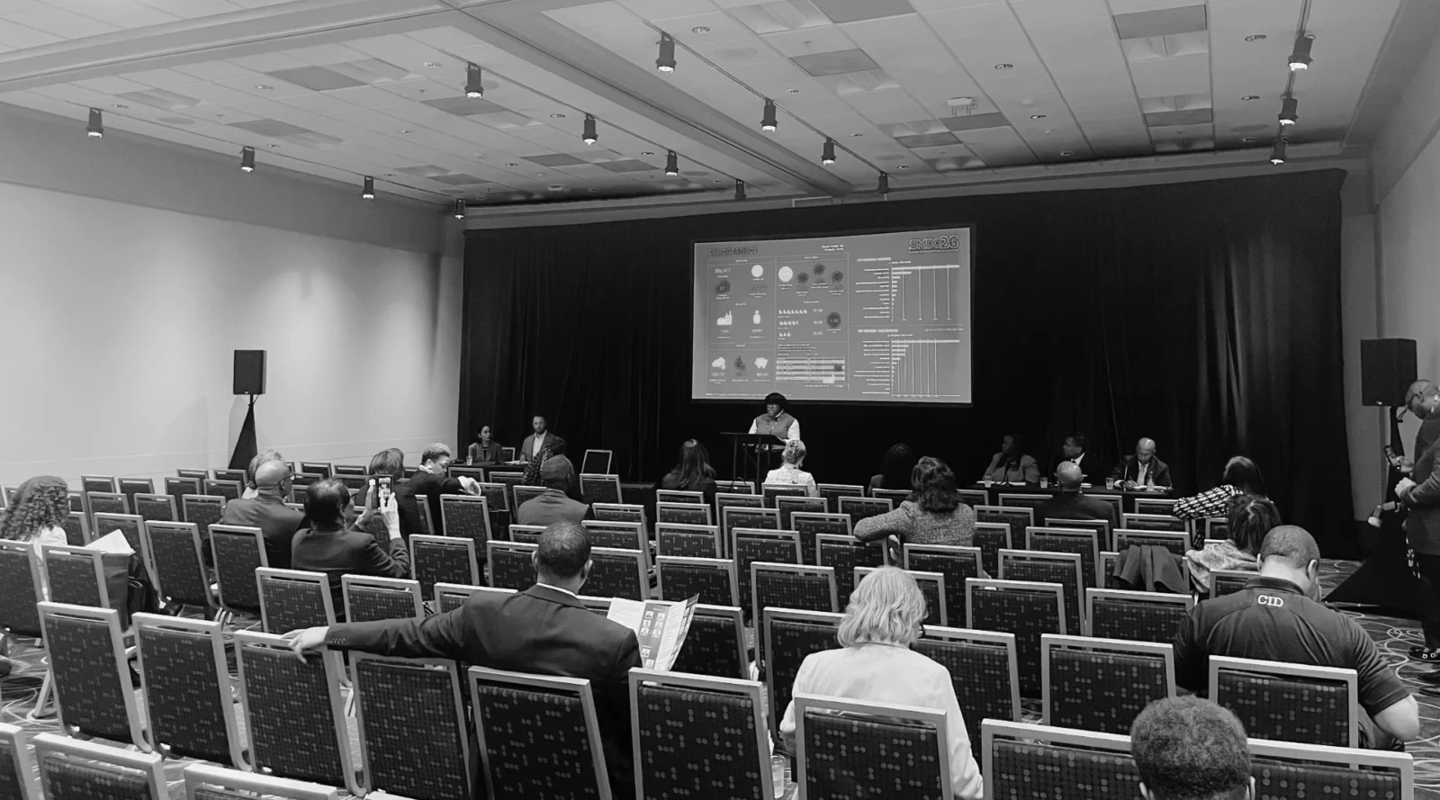 Breakout session AV production setup in Atlanta featuring projection screen, stage lighting, and audience seating for a panel discussion