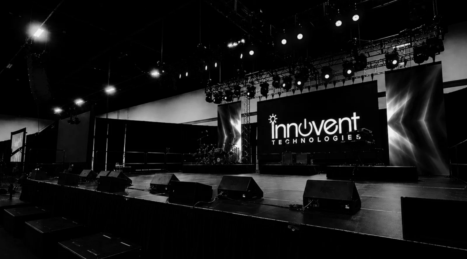 Event technology stage setup with LED wall, lighting, and AV production system for a corporate conference