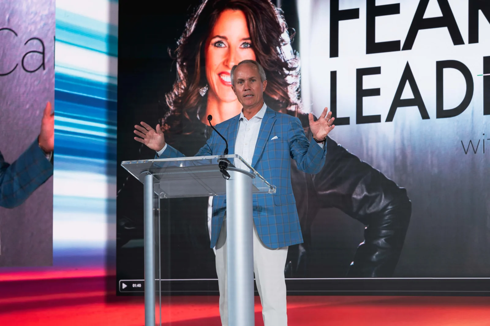 Executive Keynote Speaker Atlanta AV Production Executive speaker presenting on stage with LED video wall at corporate event in Atlanta