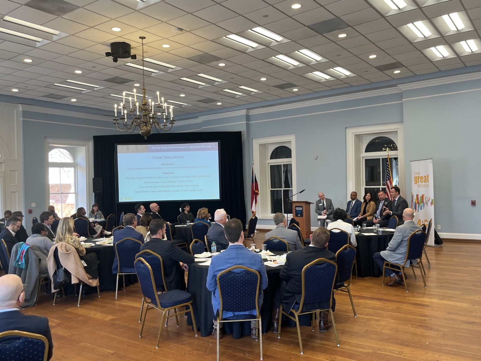 Corporate panel discussion at Georgia Freight Depot with AV production, stage, and projection screen