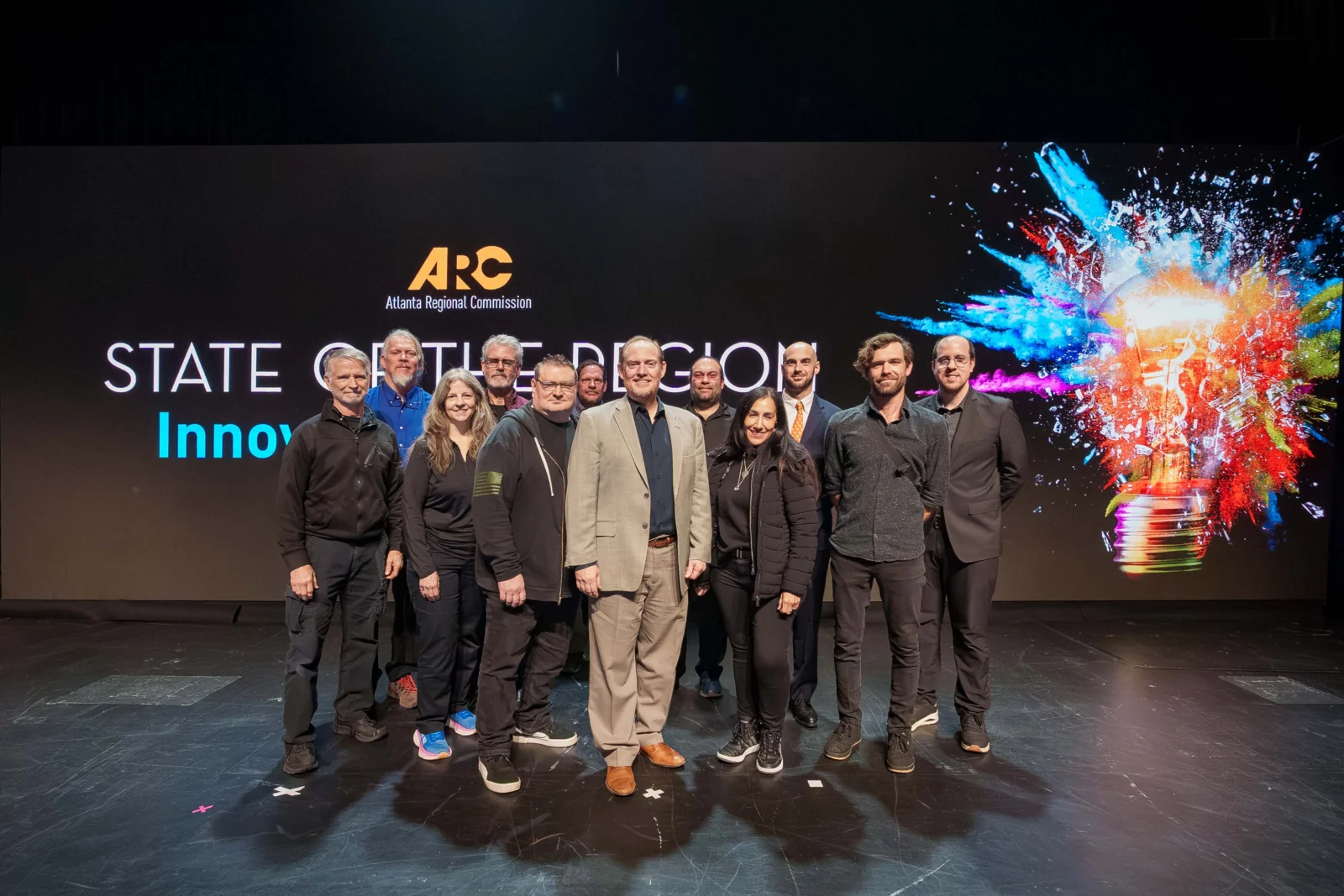 Innovent Technologies Team at ARC State of the Region LED Production Innovent Technologies production team on stage with large LED wall at ARC State of the Region event in Atlanta