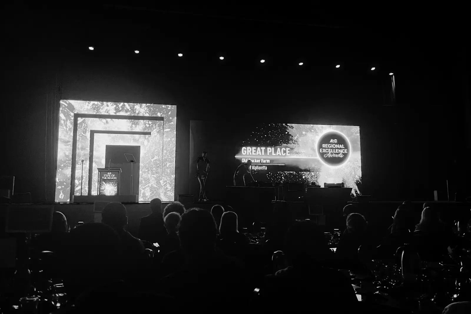 Large-scale conference stage design with LED walls, lighting, and audience for 1,000+ attendee corporate event