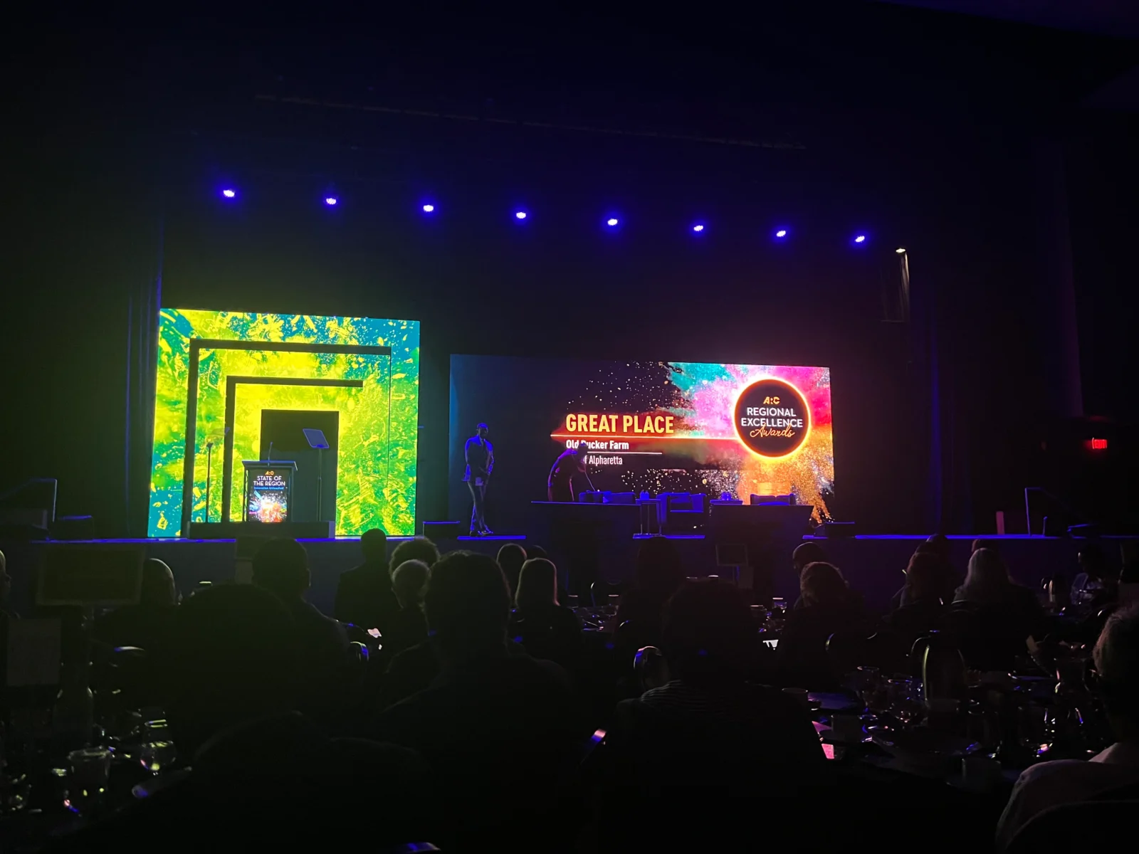 LED video wall stage setup for corporate awards event with audience and lighting design