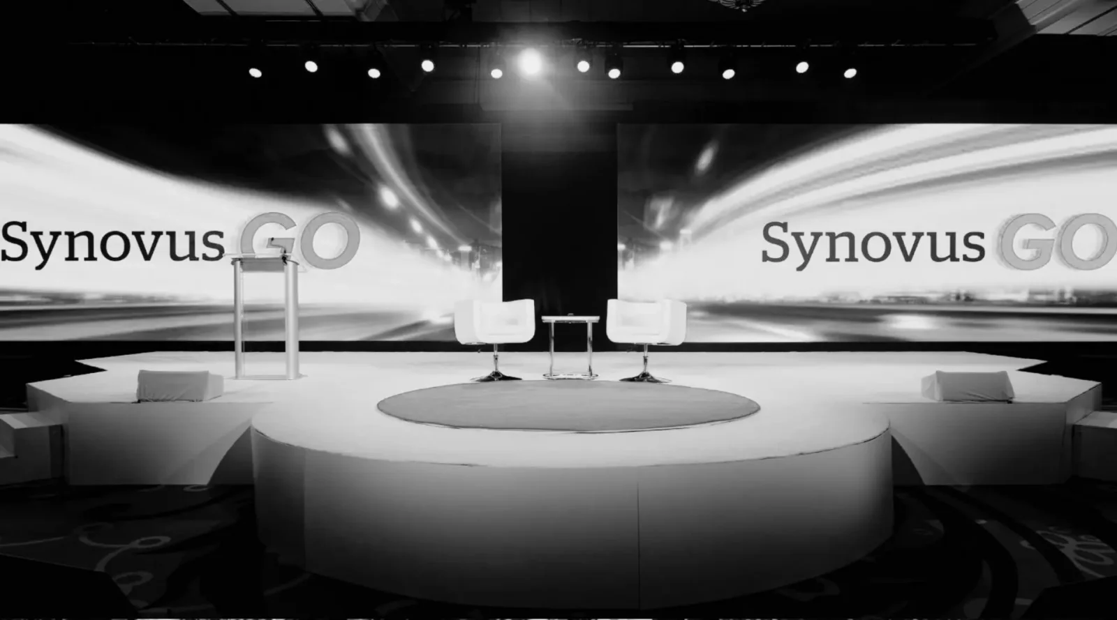 Synovus executive meeting stage with dual LED video walls and circular stage design at Cobb Galleria in Atlanta