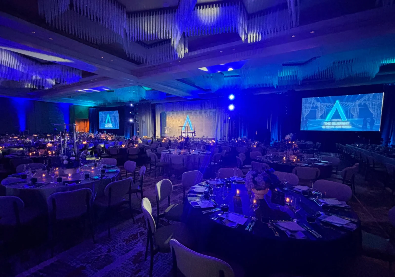 Ballroom-wide view of the 2026 Allie Awards featuring stage design, projection screens, lighting, and AV production by Innovent Technologies in Atlanta