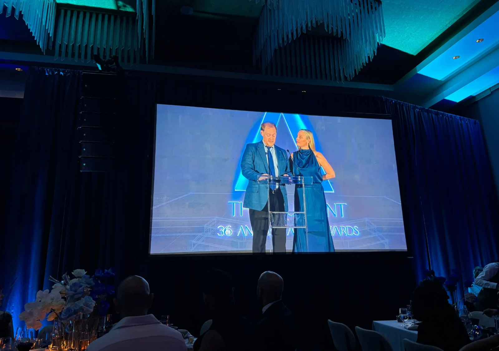Large projection screen displaying presenters during the 2026 Allie Awards with ballroom AV production by Innovent Technologies in Atlanta
