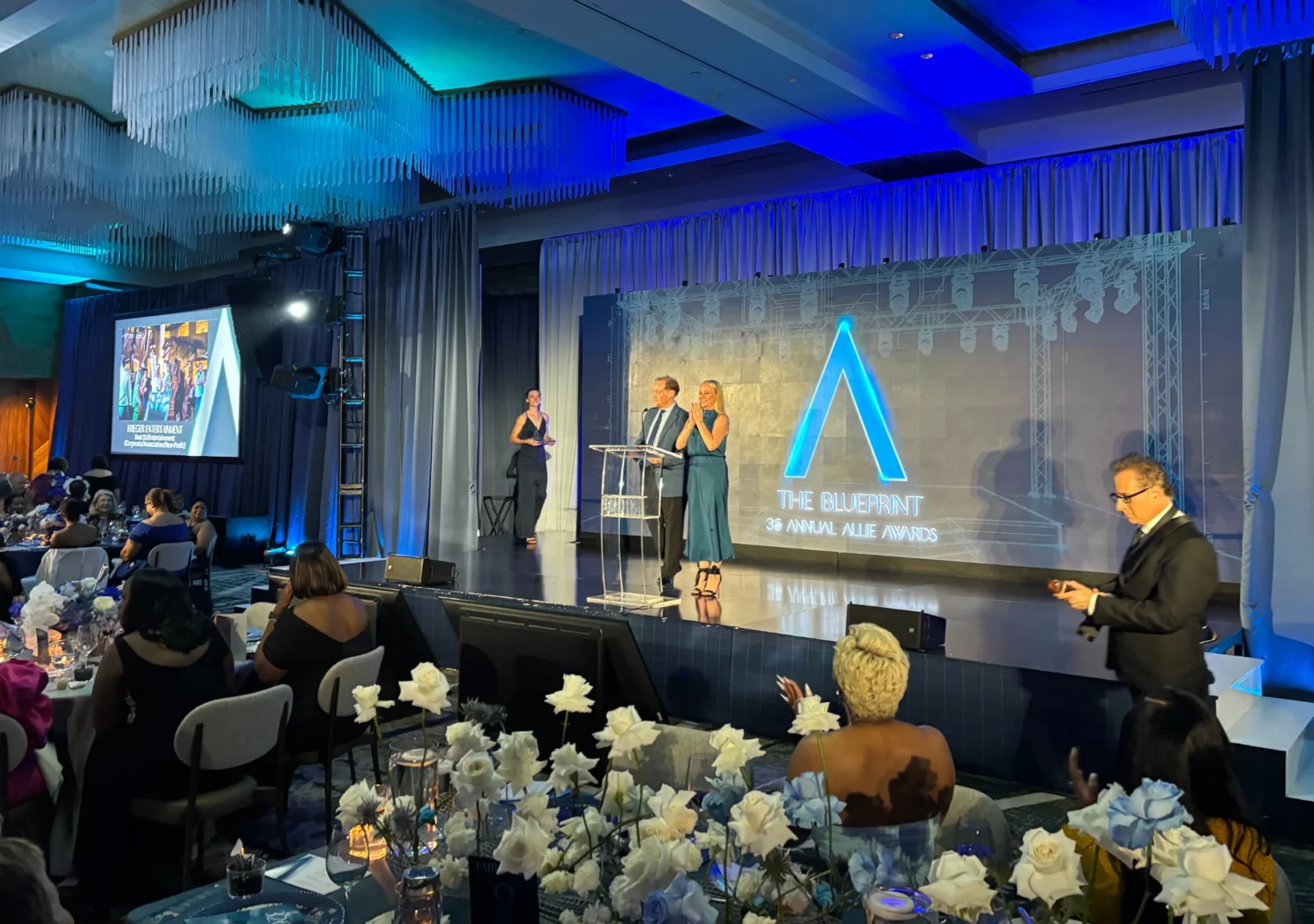 Presenters on stage during the 2026 Allie Awards with scenic staging, lighting, and AV production by Innovent Technologies in Atlanta