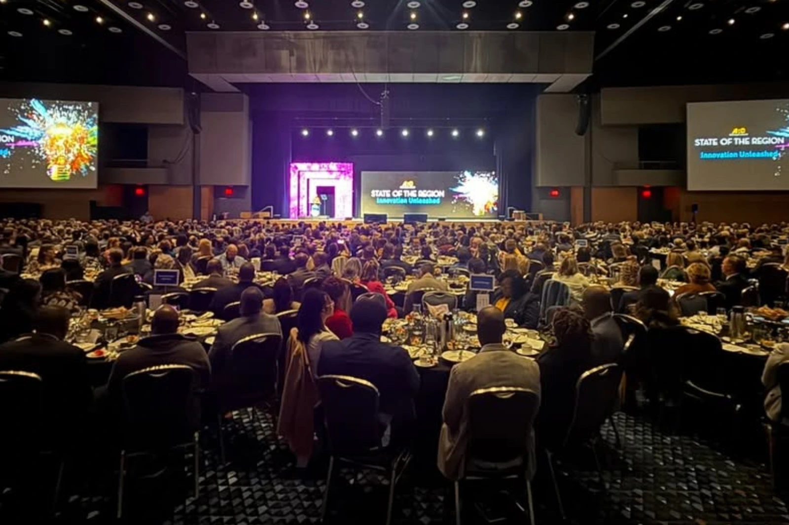 Conference general session with audience, stage design, lighting, and LED screens supported by AV production in Atlanta