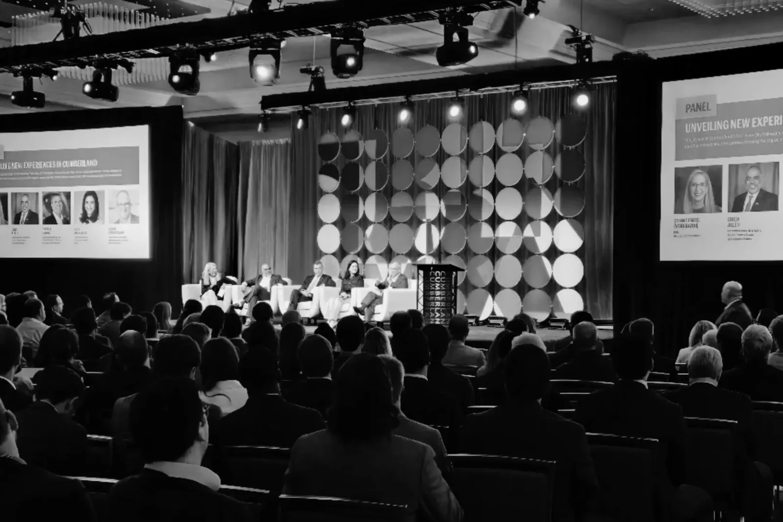 Integrated AV production for the Cumberland CID Annual Community Meeting at Cobb Galleria Centre, featuring a panel discussion, projection screens, lighting, scenic design, and a seated audience.