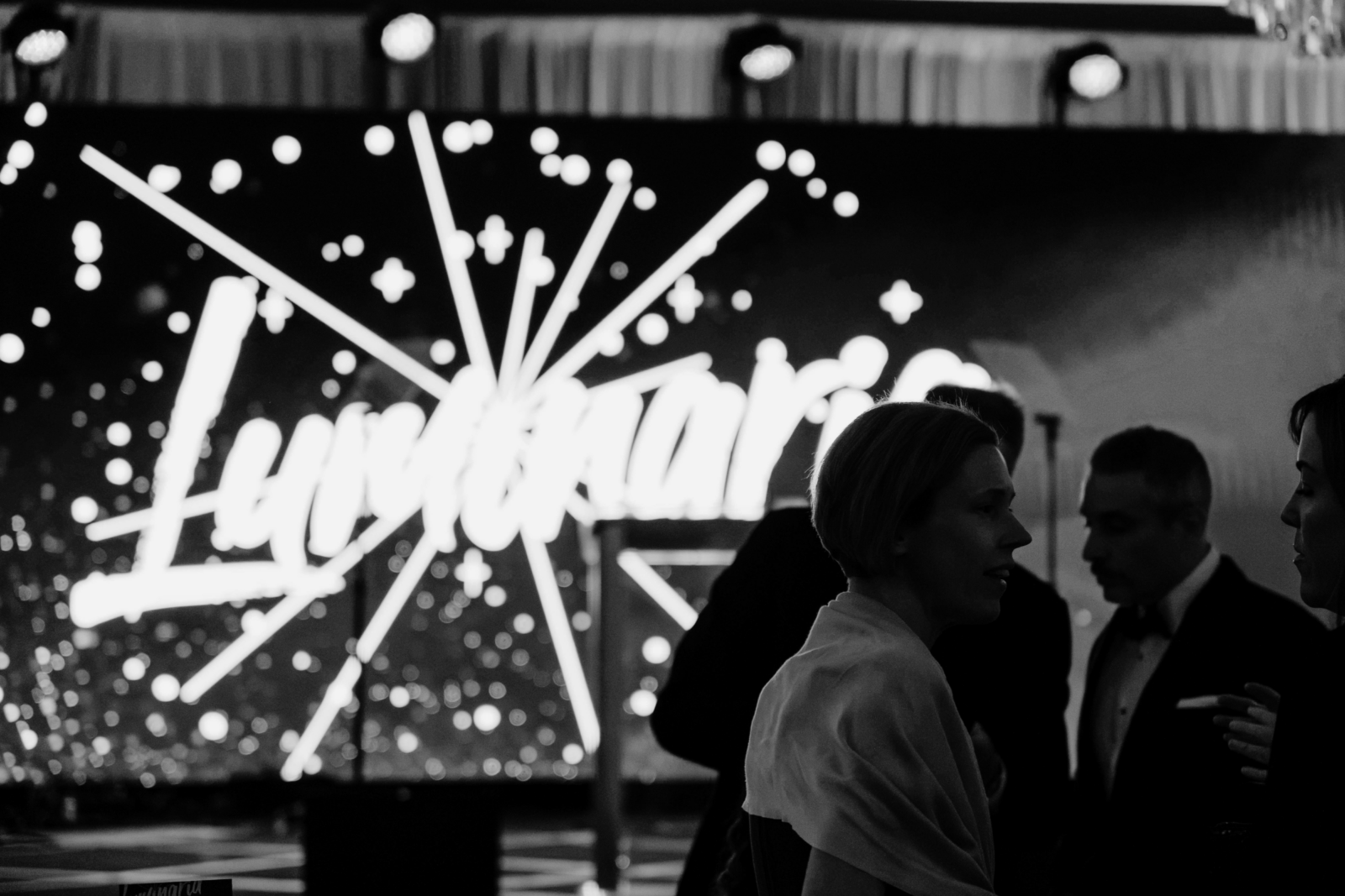Guests at Piedmont Healthcare’s Luminaria gala with an illuminated Luminaria LED display in the background