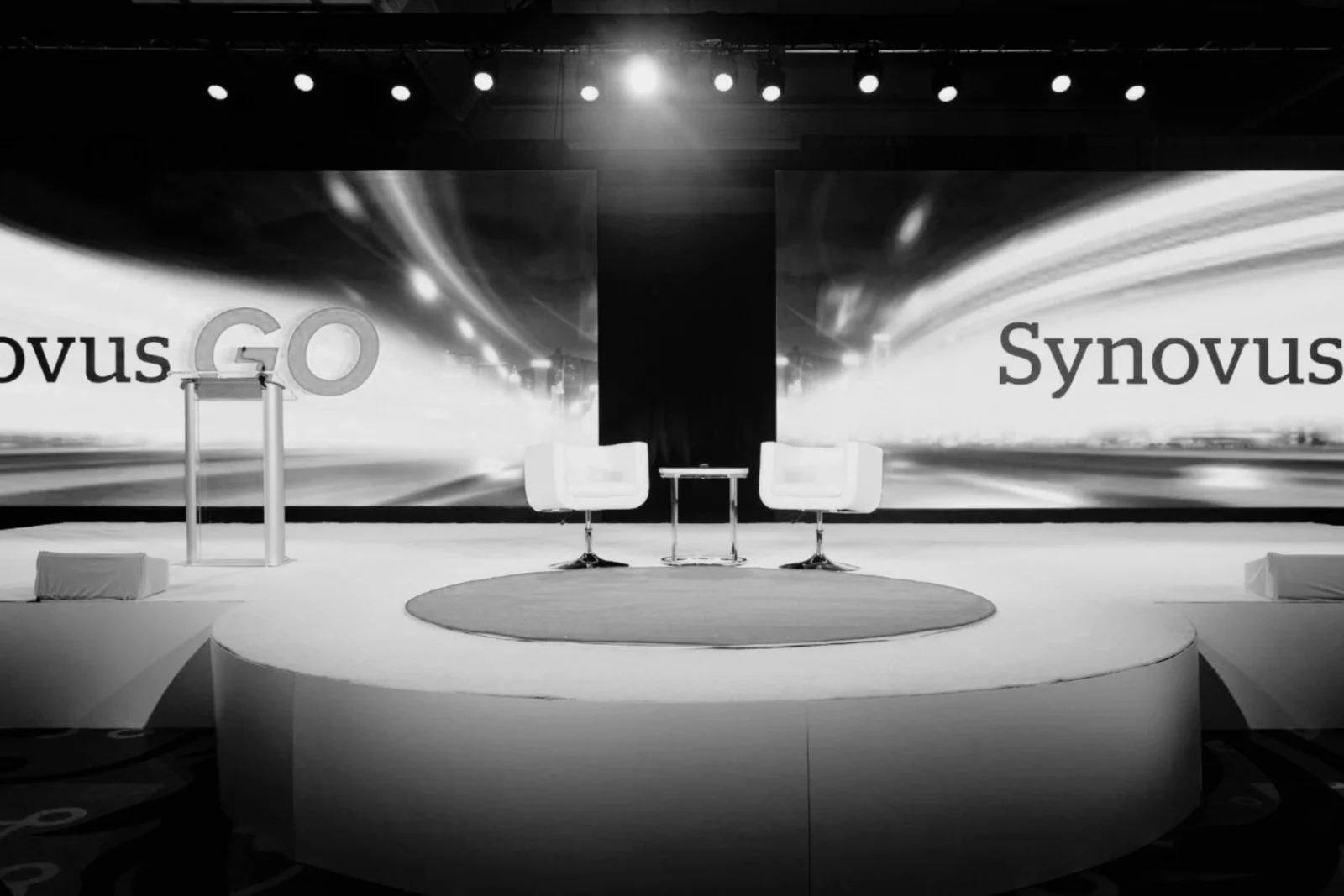 Synovus executive meeting stage with dual LED video walls and circular stage design at Cobb Galleria in Atlanta