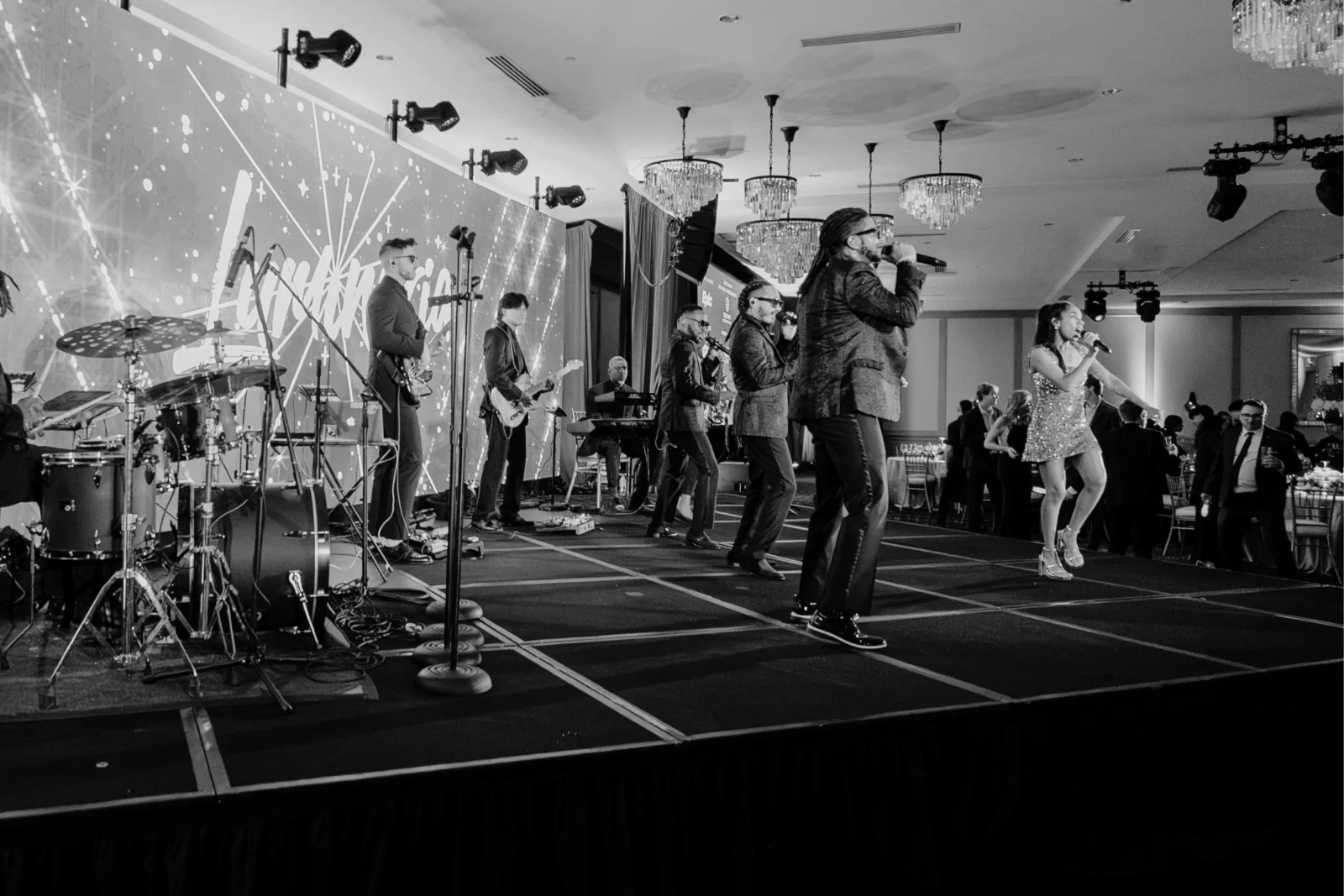 Professional AV production featuring a live band, LED video wall, stage lighting, and staging at an Atlanta gala.
